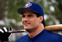 A head shot of Jose with a bat on his shoulder