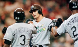 Jose is greeted at the plate after homering in Texas on 5/17/99 (AP) 