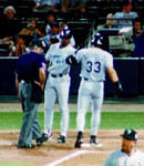 Jose being greeted at the plate after a homer during the game